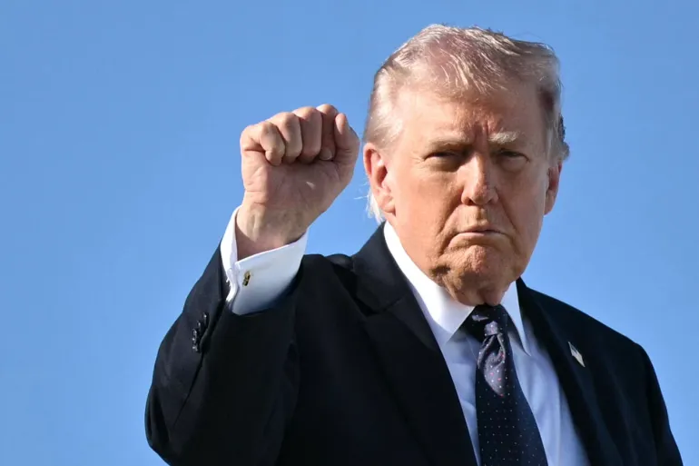 Trump gestures as he boards Air Force One on March 1, 2026 Mandel Ngan/AFP